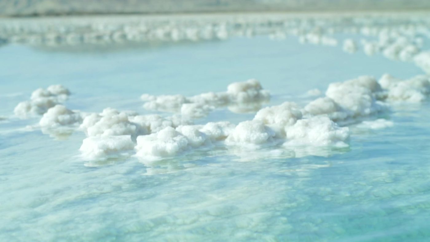White salt formations on the turquoise water of the Dead Sea
