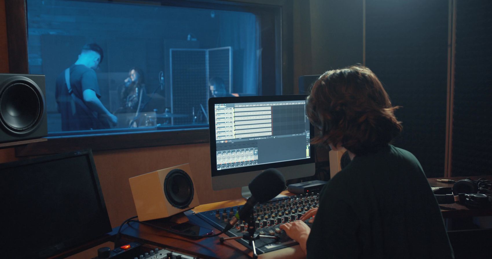 A recording studio control room with mixing desk and monitors